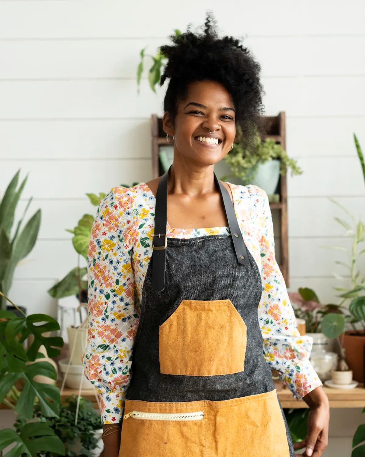 A small business owner in her plant shop, ready to accept a payment